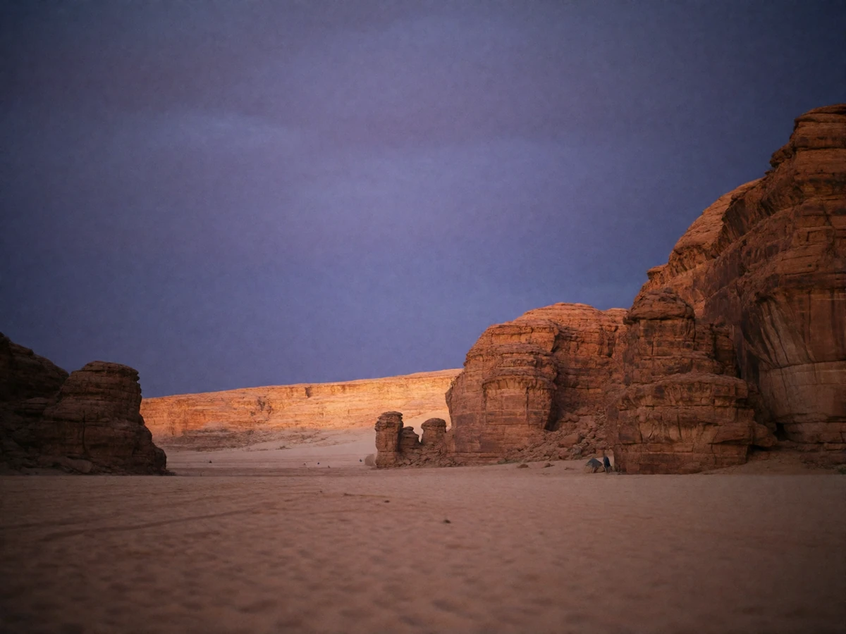 Sandstone desert valley near dusk in Western Asia with weathered rock formations under a deep violet sky