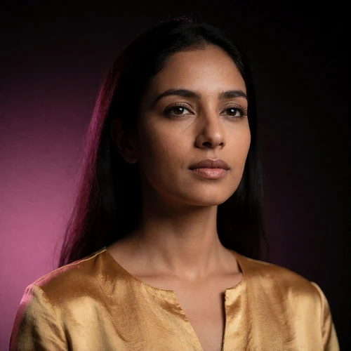 Portrait of an Indian woman in a warm gold silk top, a verified member of the Indian Dating community