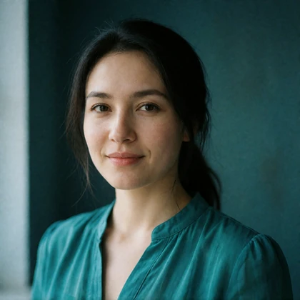 Portrait of a Kyrgyz woman in her thirties in a soft teal blouse, a verified member of the Kyrgyz Dating community