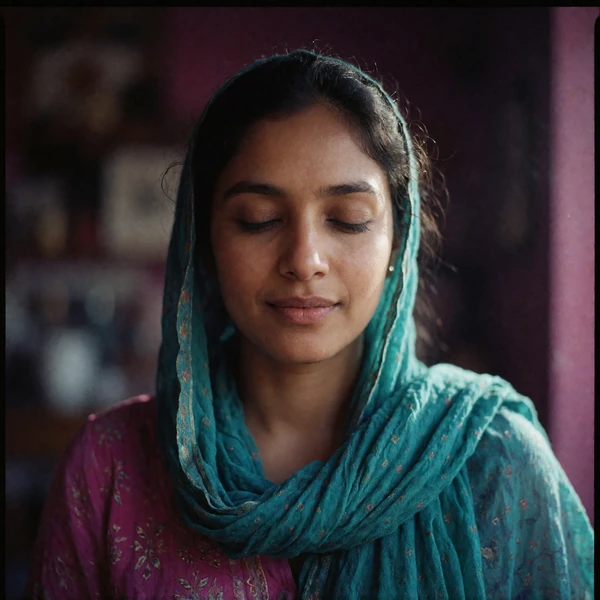 Portrait of an Afghan woman in her late twenties wearing a softly draped teal scarf, a verified member of the Afghan Dating community