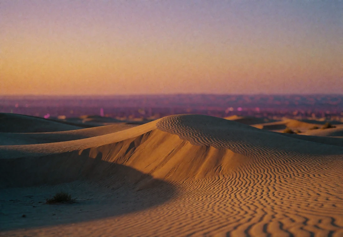 Wide dusk view of ochre desert dunes under an amber and violet sky in Central Asia, evoking the Silk Road landscape near Turkmenistan