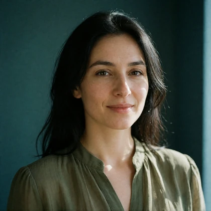 Portrait of a Turkmen woman in her thirties in a soft olive blouse, a verified member of the Turkmen Dating community