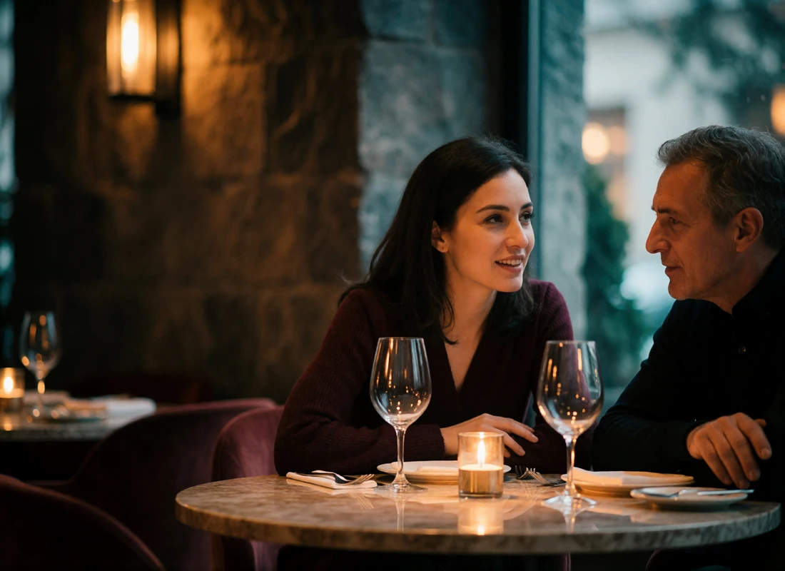 Armenian woman and an older Western man leaning toward each other in conversation at a candlelit restaurant table