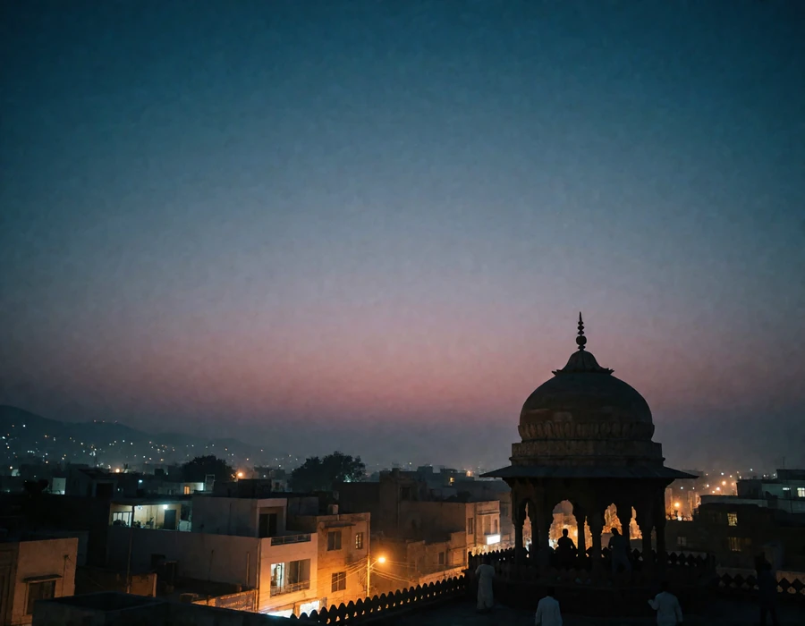 Evening skyline of a Pakistani city with a domed heritage structure silhouetted against a warm amber and indigo sky